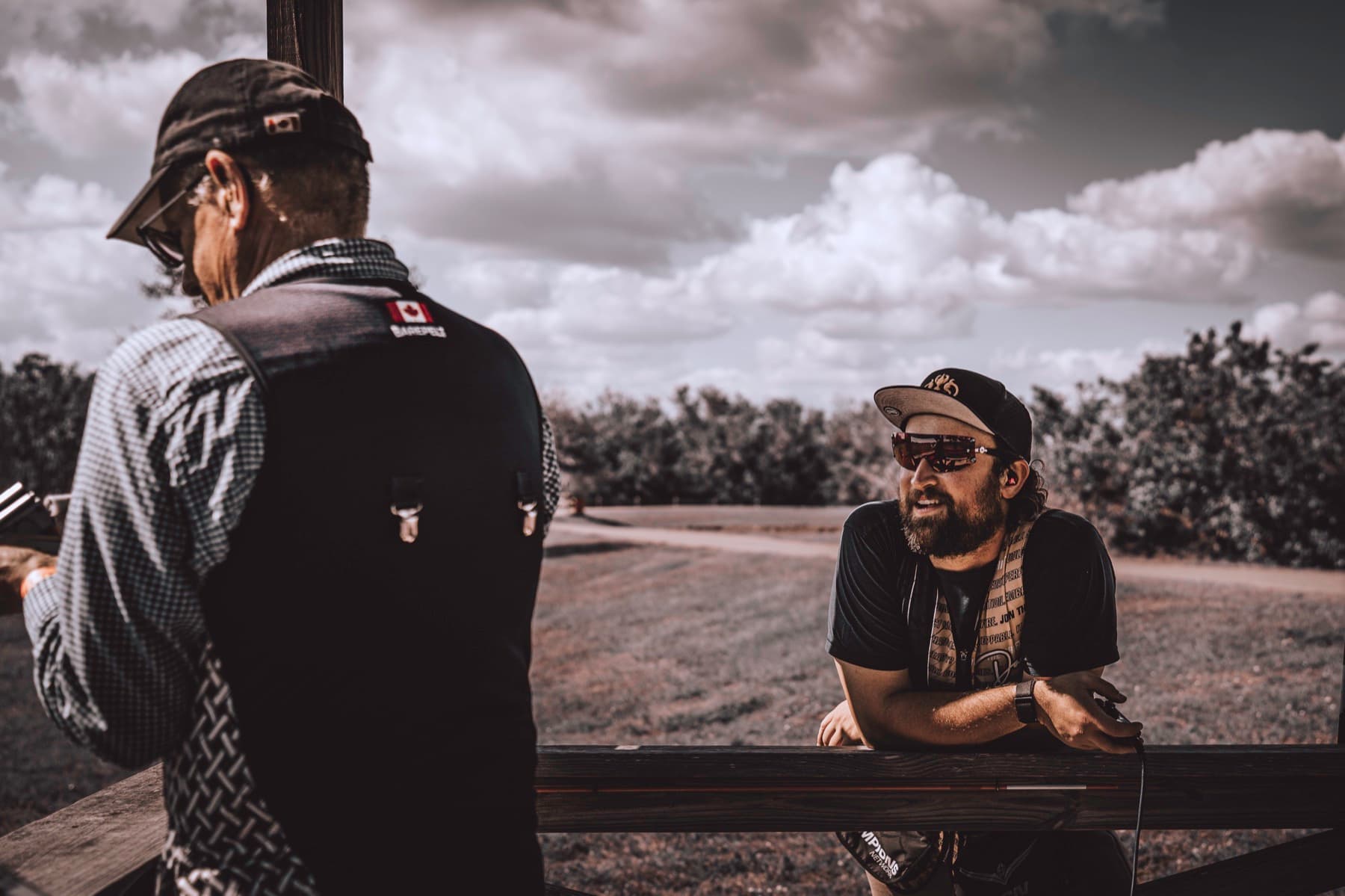 David and another shooter in conversation at a sporting clays station.