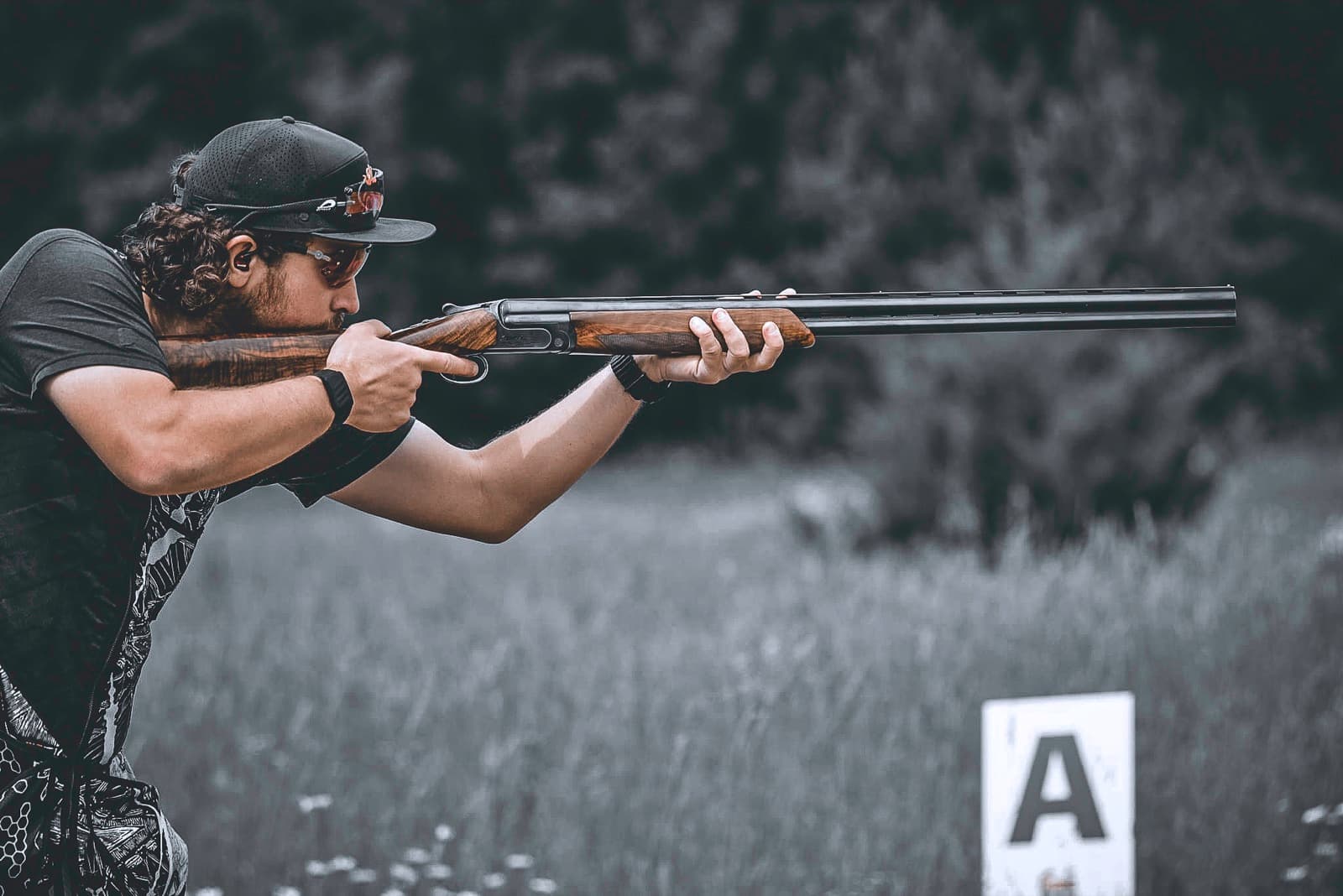 Shooter mounted on a target with the shotgun extending across the frame.